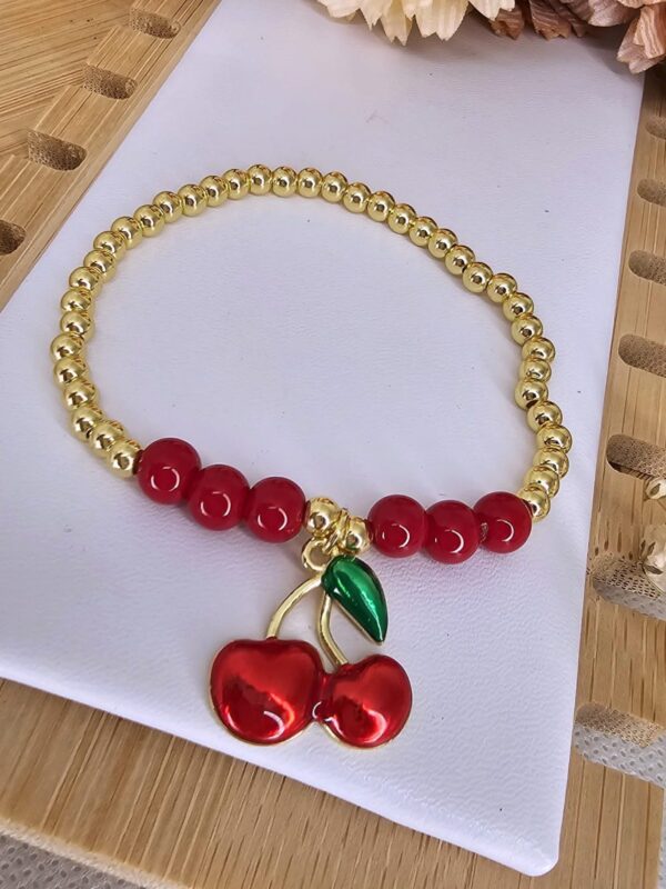 2025/06/IMG-20250530-WA0140-scaled.jpg pulsera billas cereza rojo dorado