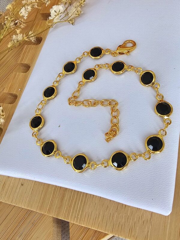 pulsera puntos negros acero dorado