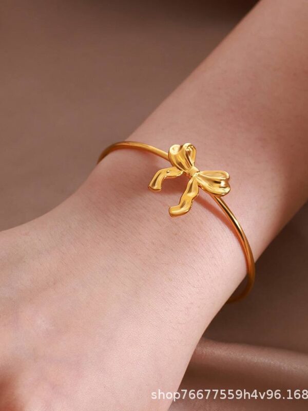 b4ca7957-c12c-4efe-8f79-2f2a4aa107ec pulsera lazo acero dorado regulable