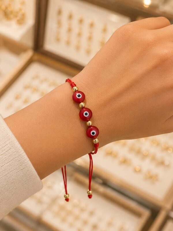 WhatsApp Image 2026-08-06 at 6.42.38 PM pulsera hilo chino rojo rodio dorado ojo turco regulable